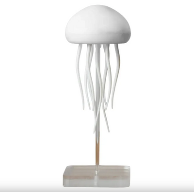 A decorative jellyfish lamp with white tentacles hanging from a rounded top, mounted on a square base.